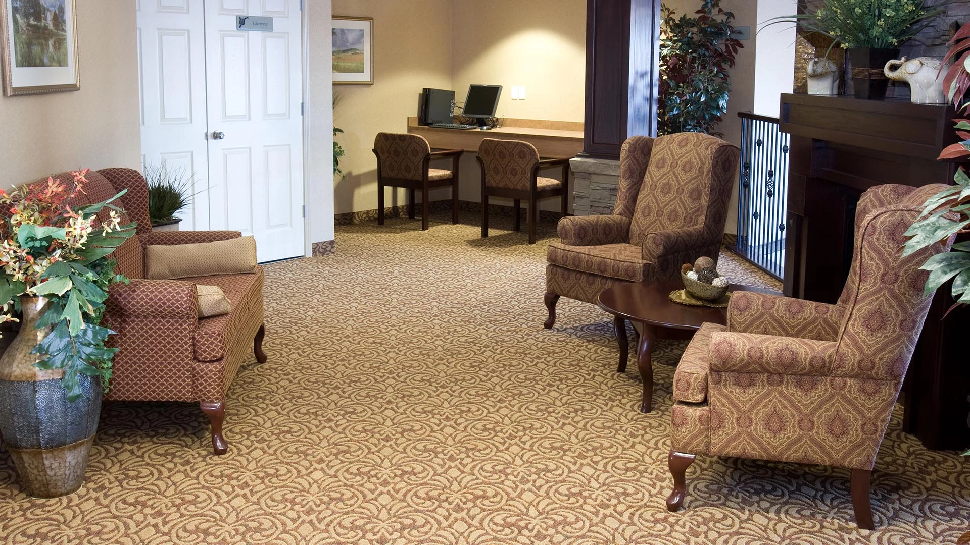 Large foyer with ample seating and a computer desk at Summerwood Village retirement home